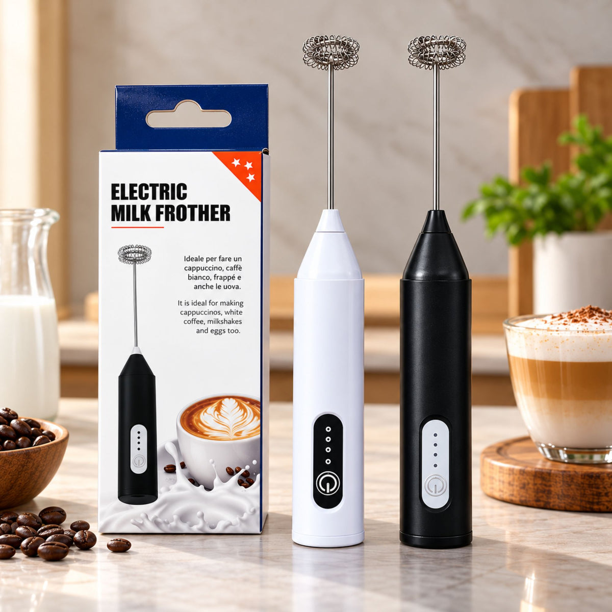 Two electric milk frothers standing on a countertop beside their retail box, with coffee cups and coffee beans in a kitchen setting. The frothers are shown in white and black, with the box labeled 'ELECTRIC MILK FROTHER'.